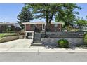 Traditional brick home with landscaped front yard, showcasing curb appeal and a welcoming entrance at 25 S Winona Ct, Denver, CO 80219