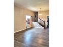 Spacious living room featuring a classic staircase and laminate flooring at 2156 Federal Blvd, Denver, CO 80211