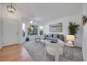 Bright and airy living room featuring neutral tones, large windows, and stylish furnishings at 8884 Miners St, Highlands Ranch, CO 80126