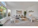 Inviting living room with plush seating, a large window, and contemporary decor at 8884 Miners St, Highlands Ranch, CO 80126