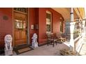 Inviting covered front porch with elegant lion statues, wooden door, and comfortable seating area at 2335 Stout St, Denver, CO 80205