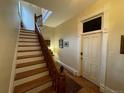 Classic foyer with hardwood floors, staircase, and decorative trim detailing throughout at 2335 Stout St, Denver, CO 80205