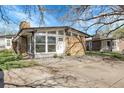 Charming brick home featuring expansive windows, inviting front door and a lush, well-maintained front yard at 5373 S Prescott St, Littleton, CO 80120