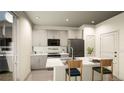 Modern kitchen with island, stainless steel appliances, and ample cabinetry at 22032 E 38Th Pl, Aurora, CO 80019