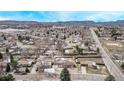 Expansive aerial view showcasing the neighborhood and mountain scenery beyond at 779 Alkire St, Lakewood, CO 80401