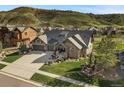 Beautiful two-story house showcasing a large driveway, well-maintained lawn, and attractive landscaping at 15116 Lyons Ridge Dr, Morrison, CO 80465