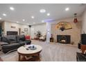 Cozy living room with a stone fireplace, plush seating, and ample lighting for relaxation at 3298 S Eudora St, Denver, CO 80222