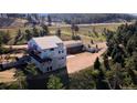 Exterior view of the property, highlighting the architectural design and construction of the home at 10550 Highway 73, Conifer, CO 80433
