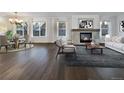 Bright living room with hardwood floors, fireplace and large windows at 2117 Collyer St, Longmont, CO 80501