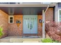 Close-up of front entrance showcasing brickwork, a light blue double door, and decorative planters at 7831 W 109Th Ave, Westminster, CO 80021