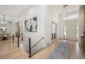 Open floor plan featuring sleek hardwood floors, modern lighting, and stylish decor at 7410 Winter Berry Ln, Castle Pines, CO 80108