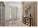 Modern entryway featuring sleek wood accents, a stylish table, and neutral decor at 7410 Winter Berry Ln, Castle Pines, CO 80108
