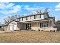 Classic two-story home featuring a brick facade, attached garage, and manicured lawn at 3257 S Geneva St, Denver, CO 80231