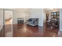 Spacious living room with hardwood floors, neutral colors, and easy access to other living areas at 3257 S Geneva St, Denver, CO 80231