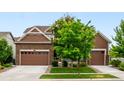 Beautifully maintained home with a manicured lawn and a charming facade, enhanced by lush greenery at 8782 S Wenatchee Ct, Aurora, CO 80016