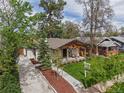 An aerial shot of a home with fresh landscaping, mature trees, and a cozy covered front porch at 2155 S Emerson St, Denver, CO 80210