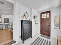 Bright entryway with a wooden door, stylish storage unit and seamless access to kitchen at 2155 S Emerson St, Denver, CO 80210