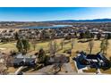 Breathtaking aerial view of the community, highlighting the lake, golf course, and mountain views at 22 Wedge Way, Littleton, CO 80123