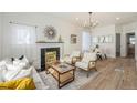 Bright living room featuring a decorative fireplace, chandelier, and modern furniture at 719 W 7Th Ave, Denver, CO 80204