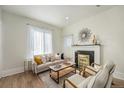 Bright living room with black fireplace, modern seating, and sunlight streaming through sheer curtains at 719 W 7Th Ave, Denver, CO 80204