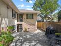 Backyard patio area with outdoor seating, barbecue grill, and access to lower level at 746 Birch St, Denver, CO 80220