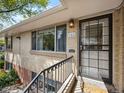 Close-up of the front entrance with a storm door, house number, and exterior lighting at 746 Birch St, Denver, CO 80220