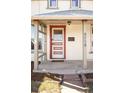 Close up of front door featuring red trim and columns supporting the small porch at 4718 W 34Th Ave, Denver, CO 80212