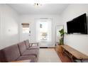 Bright living room with hardwood floors, modern furniture, and a large window, offering a welcoming space at 4718 W 34Th Ave, Denver, CO 80212