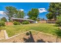 Expansive backyard with lush green grass and a privacy fence, perfect for outdoor activities at 2902 S Meade St, Denver, CO 80236