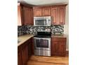 Updated kitchen featuring stainless steel appliances, granite countertops and wooden cabinets at 1245 Yates St, Denver, CO 80204
