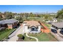 Charming single-story home with well-maintained lawn and mountain views in the background at 5491 Lowell Blvd, Denver, CO 80221