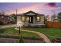 Lovely home boasting a well-kept lawn, walkway, and cozy front porch at 5491 Lowell Blvd, Denver, CO 80221