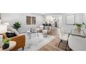 Open-concept living area with contemporary furniture and seamless flow into the kitchen at 5491 Lowell Blvd, Denver, CO 80221