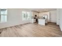 Bright, open-concept living space with hardwood floors and plenty of natural light at 708 N Bently St, Watkins, CO 80137