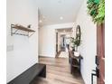 Inviting entryway with wood floors, convenient bench, stylish accents, and ample natural light at 1159 Sunrise Dr, Erie, CO 80516