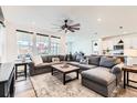 Spacious living room with large sectional sofa, ceiling fan, and lots of natural light at 1159 Sunrise Dr, Erie, CO 80516