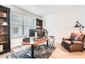 Bright home office featuring a large desk, comfortable leather chair, and ample storage at 1159 Sunrise Dr, Erie, CO 80516