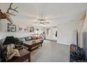 Spacious living room featuring neutral walls, soft carpet, and a ceiling fan at 9267 Welby Rd Ter, Denver, CO 80229