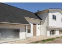 Exterior view of home featuring a black roof, light colored siding, and a brown front door at 3051 Craft Way # 2, Westminster, CO 80030