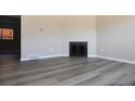 Spacious living room features wood flooring and a modern fireplace at 3051 Craft Way # 2, Westminster, CO 80030
