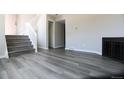 Spacious living room featuring wood flooring, fireplace, and a stairway leading to the upper level at 3051 Craft Way # 2, Westminster, CO 80030