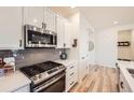 Contemporary kitchen design featuring stainless steel appliances and hardwood floors at 515 176Th Ave, Broomfield, CO 80023