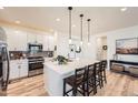 Modern kitchen with quartz countertops, pendant lighting, and stainless steel appliances at 515 176Th Ave, Broomfield, CO 80023