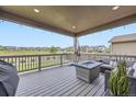 Enjoy the outdoor covered patio, equipped with lounge furniture, a fire pit, and a scenic neighborhood view at 515 176Th Ave, Broomfield, CO 80023