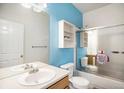 Bright bathroom features vanity with ample counter space and sliding glass doors on tub/shower at 12943 N Lafayette St # H, Thornton, CO 80241