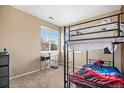 Bedroom featuring a black bunkbed and window for natural light at 12943 N Lafayette St # H, Thornton, CO 80241