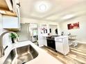 Bright kitchen offering modern countertops, stainless steel appliances, and seamlessly connects to the living space at 8820 Cody St, Broomfield, CO 80021