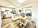Open-concept kitchen featuring modern appliances, white cabinetry, and a seamless transition to the living area at 8820 Cody St, Broomfield, CO 80021