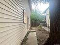 View of the side yard with a fence and overgrown grass at 1413 Centennial Dr, Longmont, CO 80501