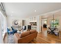 Open-concept living area with hardwood floors connecting the living and dining spaces at 1370 S Hudson St, Denver, CO 80222
